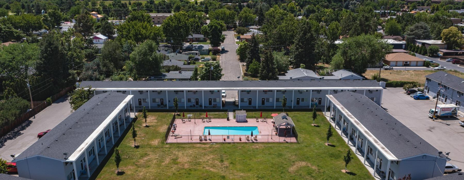 a high angle view of a parking lot and courtyard with a pool